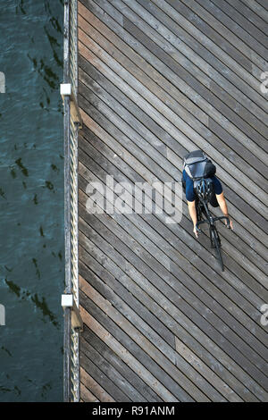 A man rides a bicycle. Bicycle as a means of transportation is chosen by real lovers of a healthy active lifestyle, which implies physical exercise on Stock Photo