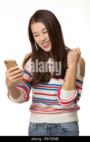 Beautiful Asian woman using a smart phone to send a text message isolated on a white background Stock Photo