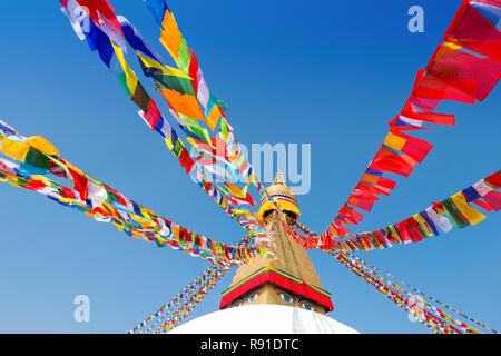 Prayer flags against a blue sky at Boudhanath Stupa in Kathmandu, Nepal Stock Photo