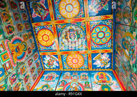 Highly decorative paintings of mandalas inside a Tibetan Kani (village entrance arch ), Nepal Stock Photo