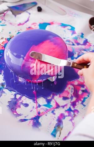 Process of decorating cake with mirror glaze Stock Photo