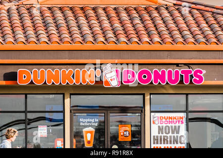 December 17, 2018 Half Moon Bay / CA / USA - Dunkin' Donuts sign above the entrance to the location in Half Moon Bay Stock Photo