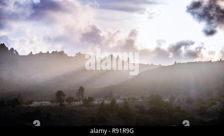 Rays of light illuminating the hills surrounding Crystal Springs Reservoir, San Francisco bay area, California Stock Photo