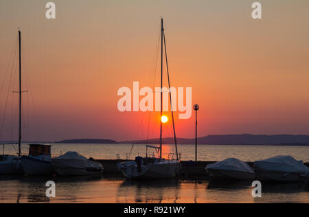 Boats on the Trasimeno lake at sunset in Umbria, Italy Stock Photo