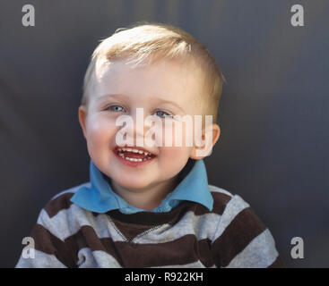 Head and shoulder portrait of happy young caucasian toddler child