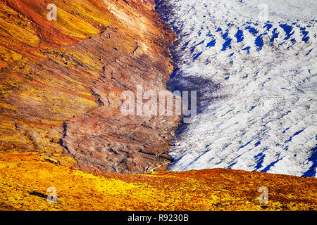 The Skaftafellsjokull glacier. Like all Iceland's glaciers it is receding rapidly due to climate change. Scientists predict that all Iceland's glaciers will have disappeared within 100 years. The glaciers retreat is clearly visible on the left hand side where bands of maroaine have been deposited by the retreating glacier. Stock Photo