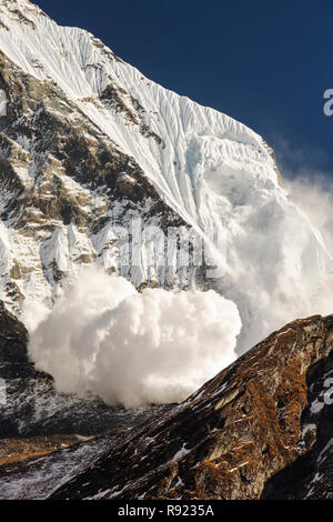 Avalanche on Fishtail Peak caused by massive block of glacial ice detaching from summit cliffs, Nepal Stock Photo