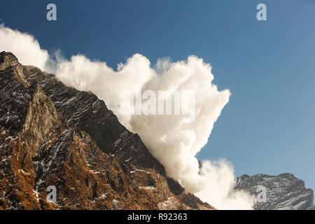 Avalanche on Fishtail Peak caused by massive block of glacial ice detaching from summit cliffs, Nepal Stock Photo