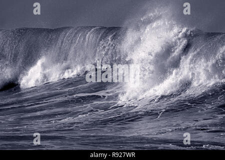 Big ocean wave crashes on to the Protuguese coast - Toned black and white Stock Photo