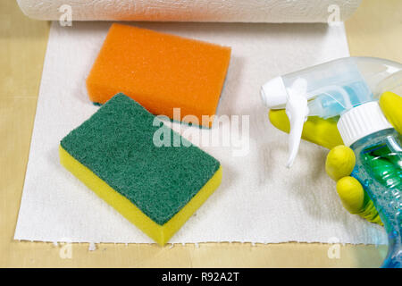 Sponge and liquid for cleaning the surface at home. Accessories for keeping household clean. Light background. Stock Photo