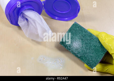 Sponge and liquid for cleaning the surface at home. Accessories for keeping household clean. Light background. Stock Photo