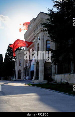 Two Turkey flags waving in the wind against the sun light Stock Photo