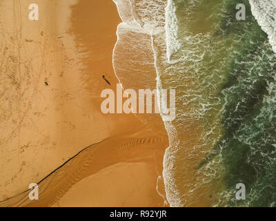 Alone man watching the ocean in a beach. Aerial view from a fisherman, Stock Photo