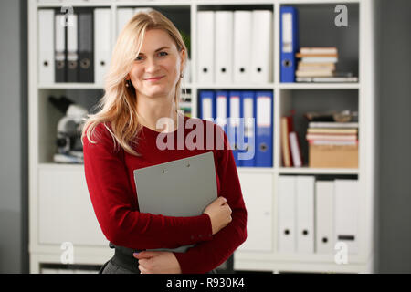 Happy smiling blond businesswoman holdig Stock Photo