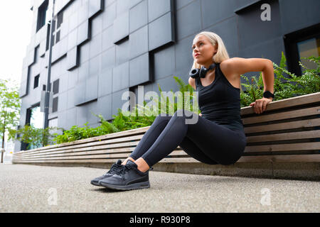 Welltrained Happy Young Woman Doing Triceps Dips in the City Stock Photo