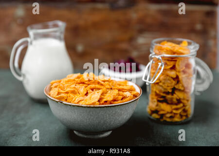 cornflakes cereal and milk in a glass. Morning tasty breakfast concept Stock Photo