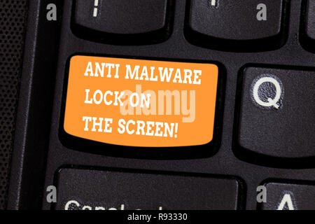 Handwriting text writing Anti Malware Lock On The Screen. Concept meaning Security safety against malware hacking Keyboard key Intention to create com Stock Photo