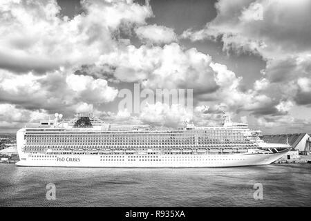 Bridgetown, Barbados - December 12, 2015: P O Cruises. Azura cruise ship docked in sea port on cloudy sky. Transportation. Travelling by sea. Recreation and summer vacation. Stock Photo