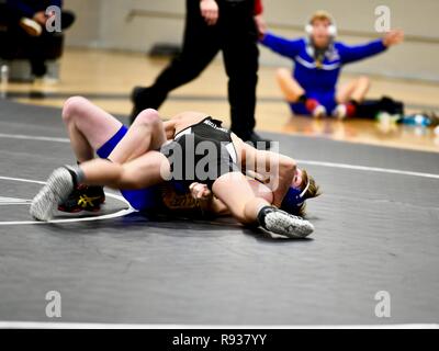 High school wrestler getting pinned by his opponent. Stock Photo