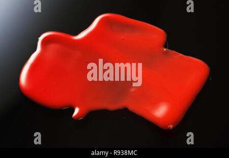 Texture of Red Lipgloss Liquid, Black Background Stock Photo