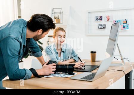 professional young photographers using drawing tablet and retouching photos Stock Photo