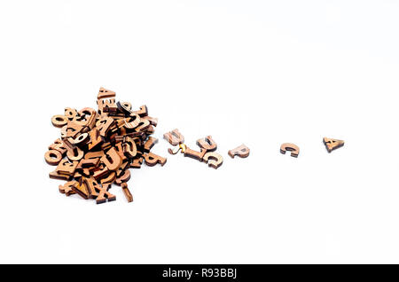 pile scattered mixed brown wooden letters of the English alphabet on white background, copy space Stock Photo