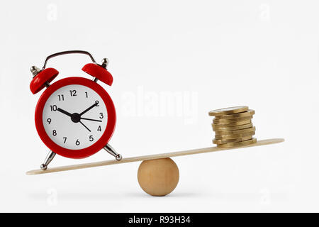 Clock and money on scales - Importance of time, time and money concept Stock Photo