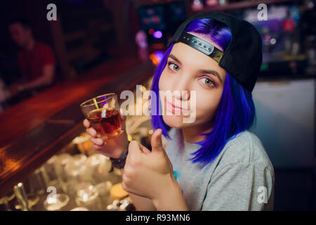 female bartender. girl with blue hair. cocktail making in night bar Stock Photo