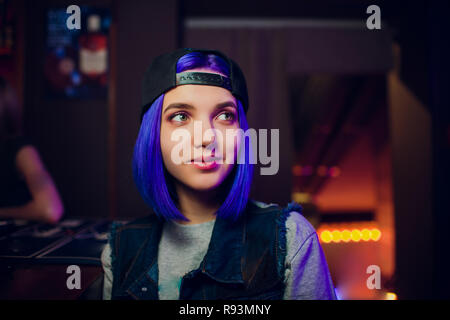 female bartender. girl with blue hair. cocktail making in night bar Stock Photo