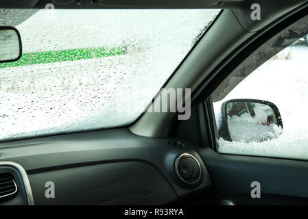car window under a layer of snow -internal look,Winter frozen car window inside view Stock Photo