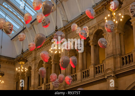 Glasgow, Scotland, UK - December 14, 2018: The Floating heads installation created by Sophie Cave within Kelvingrove Museum in Glasgow which is free e