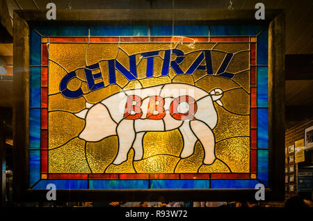 A pig-themed stained glass window hangs inside Central BBQ, Sept. 14, 2015, on Central Aveue in Memphis, Tennessee. Stock Photo