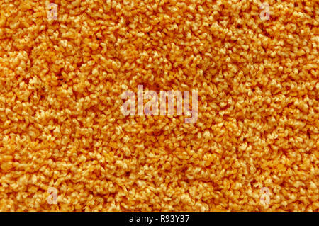 Orange wool carpet texture. Abstract background. Macro. Stock Photo