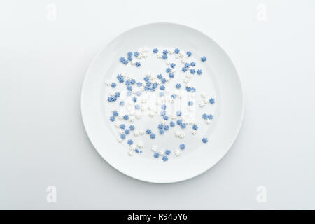 Abstract white plate with sweet snowflakes as Christmas menu decoration template in minimalist style on white background. Christmas dinner concept, flat lay Stock Photo