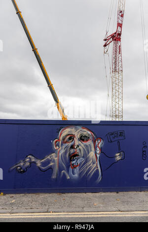 grafitti on the side of building site hoarding Stock Photo