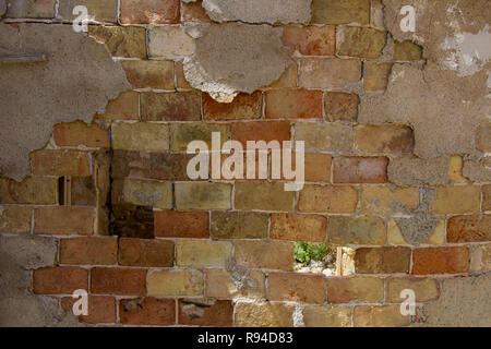 old brick wall, mud brick wall, worn brick Stock Photo