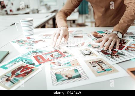 Stylist from fashion school choosing the pictures for new catalogue Stock Photo