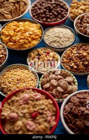Assortment of different kinds cereals placed in ceramic bowls on table Stock Photo
