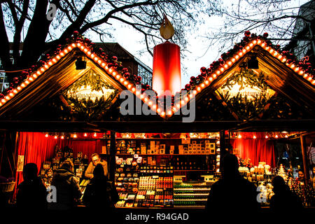People browsing a sweet stall in the traditional Christmas market at Munster in Germany Stock Photo