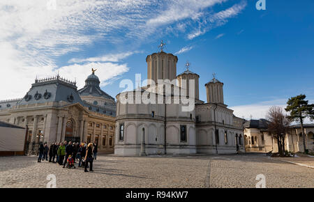 BUCHAREST, ROMANIA - DECEMBER 8: Tourists walk by the Catedrala Patriarhala Sfintii Imparati Constantin si Elena (Patriarchal Cathedral of Saints Constantine and Helena) on December 8, 2018 in Bucharest, Romania. Many churches survived in the city the destruction of the Ceausescu era. Stock Photo