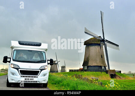 Tourists in a motorhome with the windmills at the Schermerhorn Windmill Museum,Noordervaart 2, Schermerhorn, Holland, Netherlands Stock Photo