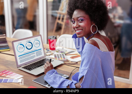 Manager of creative fashion project smiling while working Stock Photo