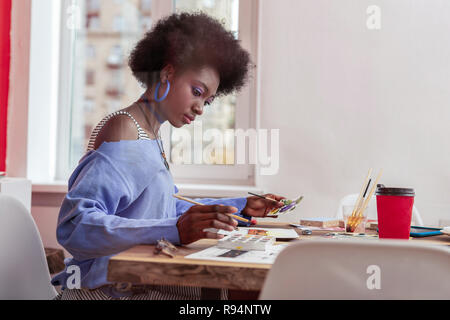 Interior designer holding painting brush making sketches for new project Stock Photo