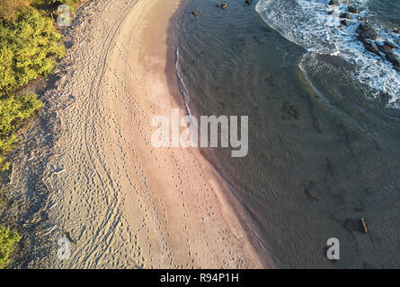 People traces on ocean beach aerial drone view