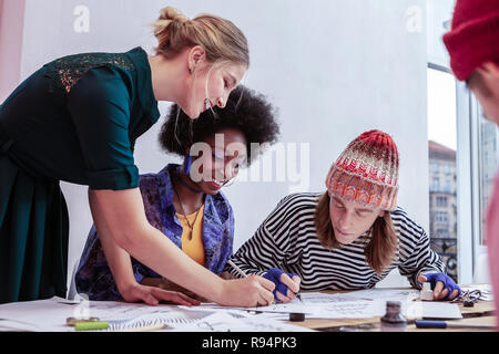 Young teacher feeling good while interacting with her students Stock Photo