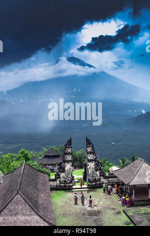 Bali, Indonesia - 08 March 2018: Summer landscape with Pura Penataran Agung Lempuyang temple and tourists group. Candi bentar and view to Agung mount  Stock Photo