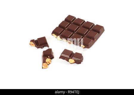 bar of dark chocolate with hazelnuts. Pieces of chocolate with nuts, isolated on white background. Stock Photo
