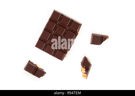 bar of dark chocolate with hazelnuts. Pieces of chocolate with nuts, isolated on white background. Stock Photo