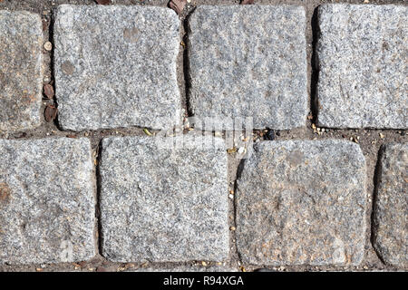 Gray square cobblestones in the street Stock Photo