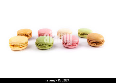 Rows of colorful French macarons isolated on white Stock Photo